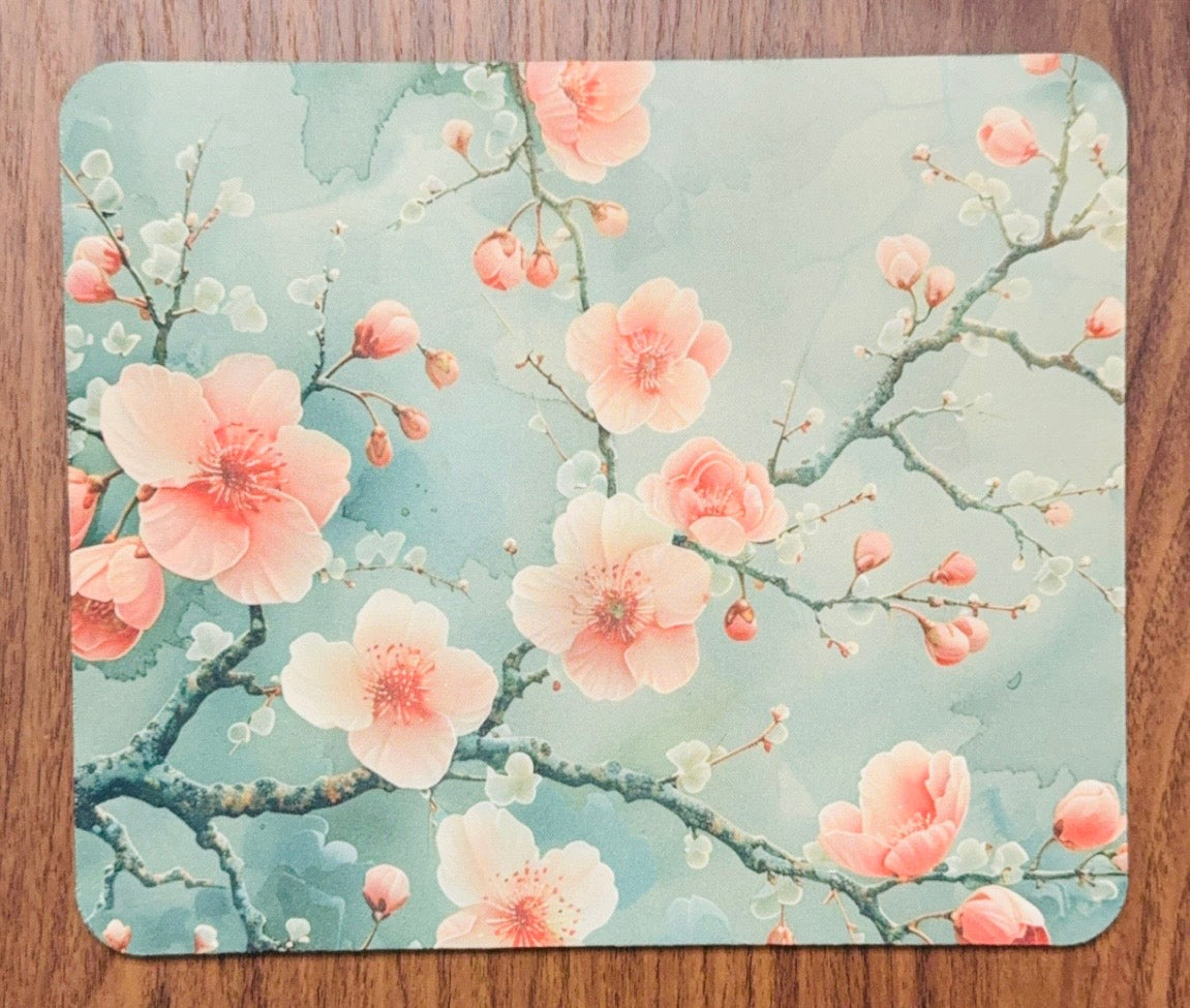 Pink cherry blossom mouse pad featuring elegant sakura flowers on a soft floral background by Chela Created LLC.