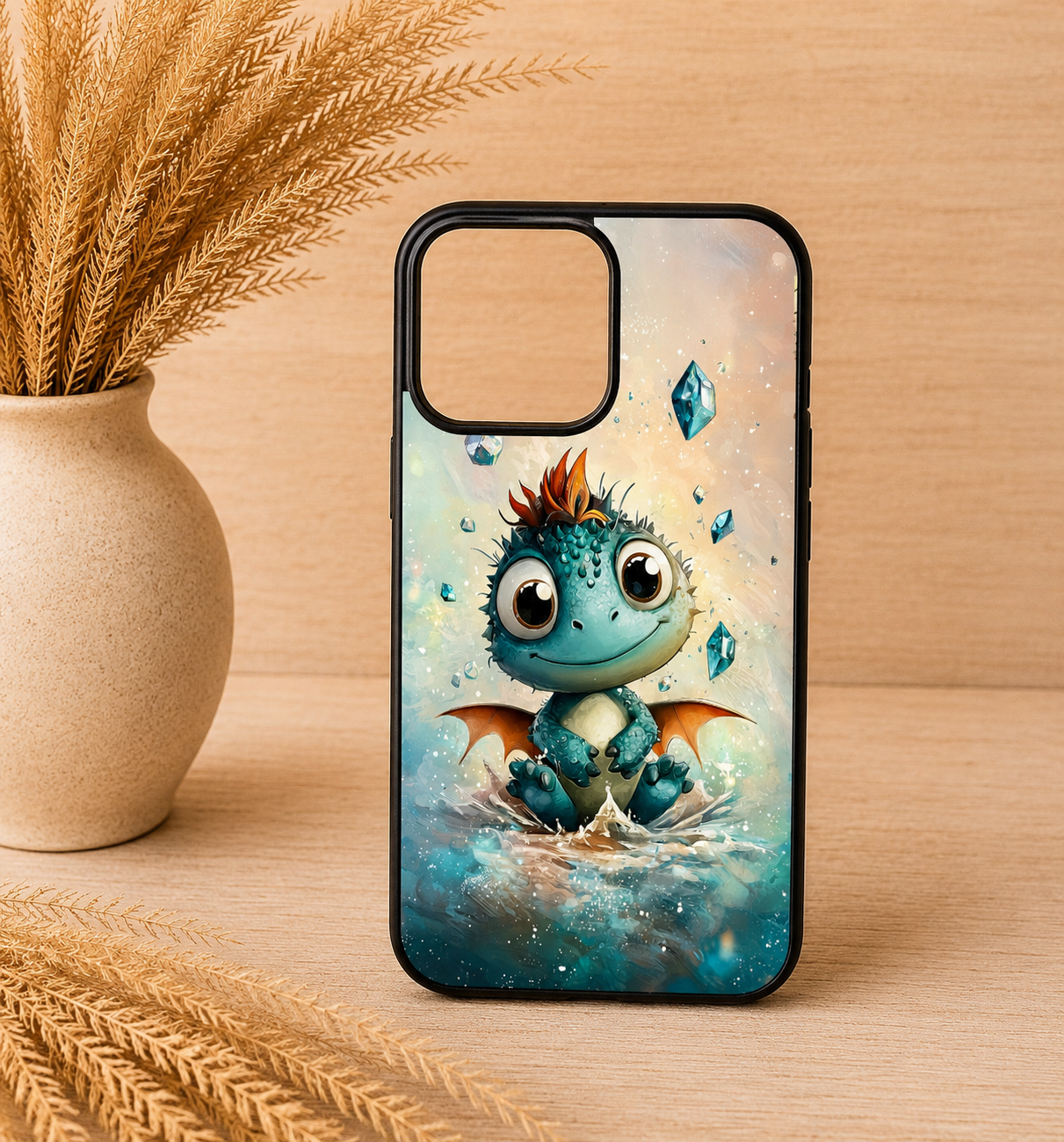 Cute teal baby dragon fantasy phone case with black trim displayed on a neutral boho wood background with pampas grass.